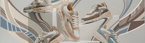 A group of chunky Floris van Bommel platform sneakers displayed on white pedestals against a stylized beige, brown, and blue graphic background. The shoes feature thick platform soles and a retro multi-panel design in neutral tones with some light blue accents.