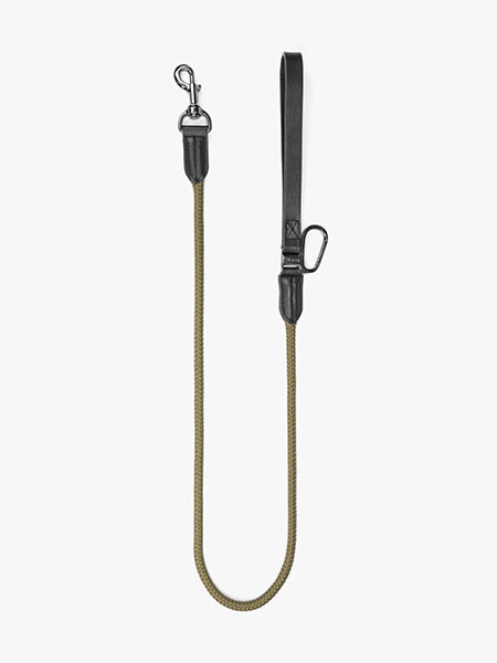 Dog leash Floris van Bommel. A dog leash with a braided olive-green rope, black leather handle, and silver metal hardware.