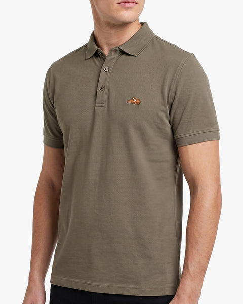 Floris van Bommel. A man wearing a short-sleeve polo shirt in olive green with a small embroidered logo on the left chest, shown against a plain light background.